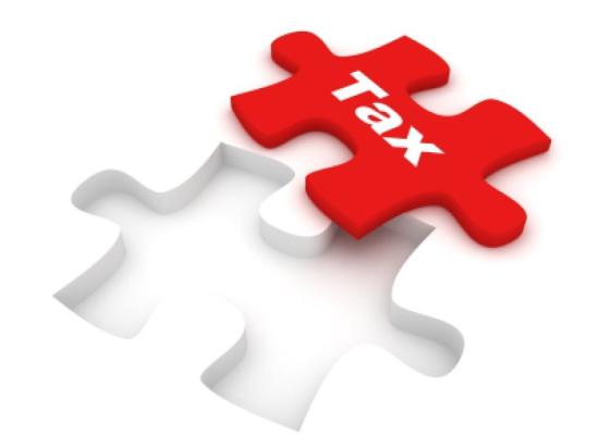 Puzzle Piece With the Word Tax 